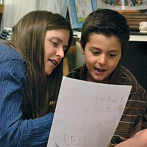 teacher and student looking at student work